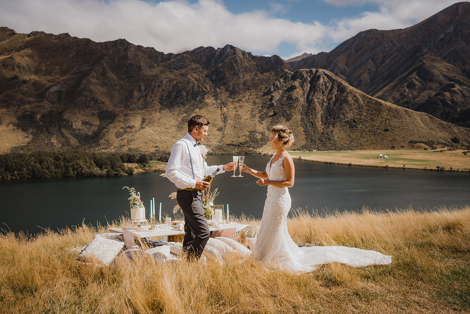 Wedding couple toasting with picnic by Moke Lake
