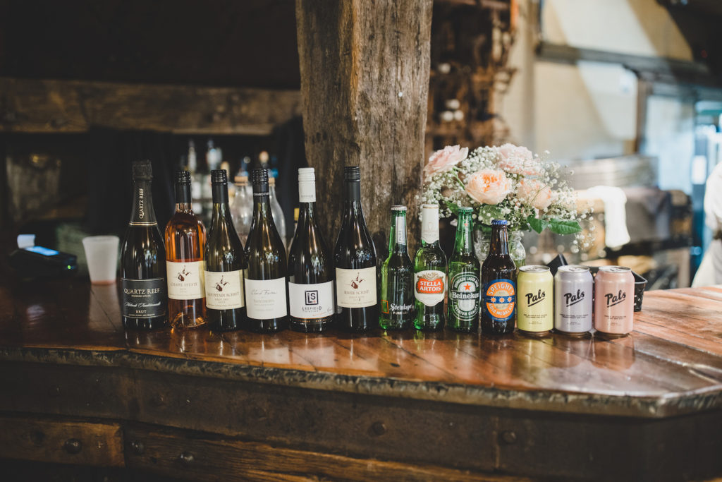 Alcoholic drinks lined up at a wedding bar